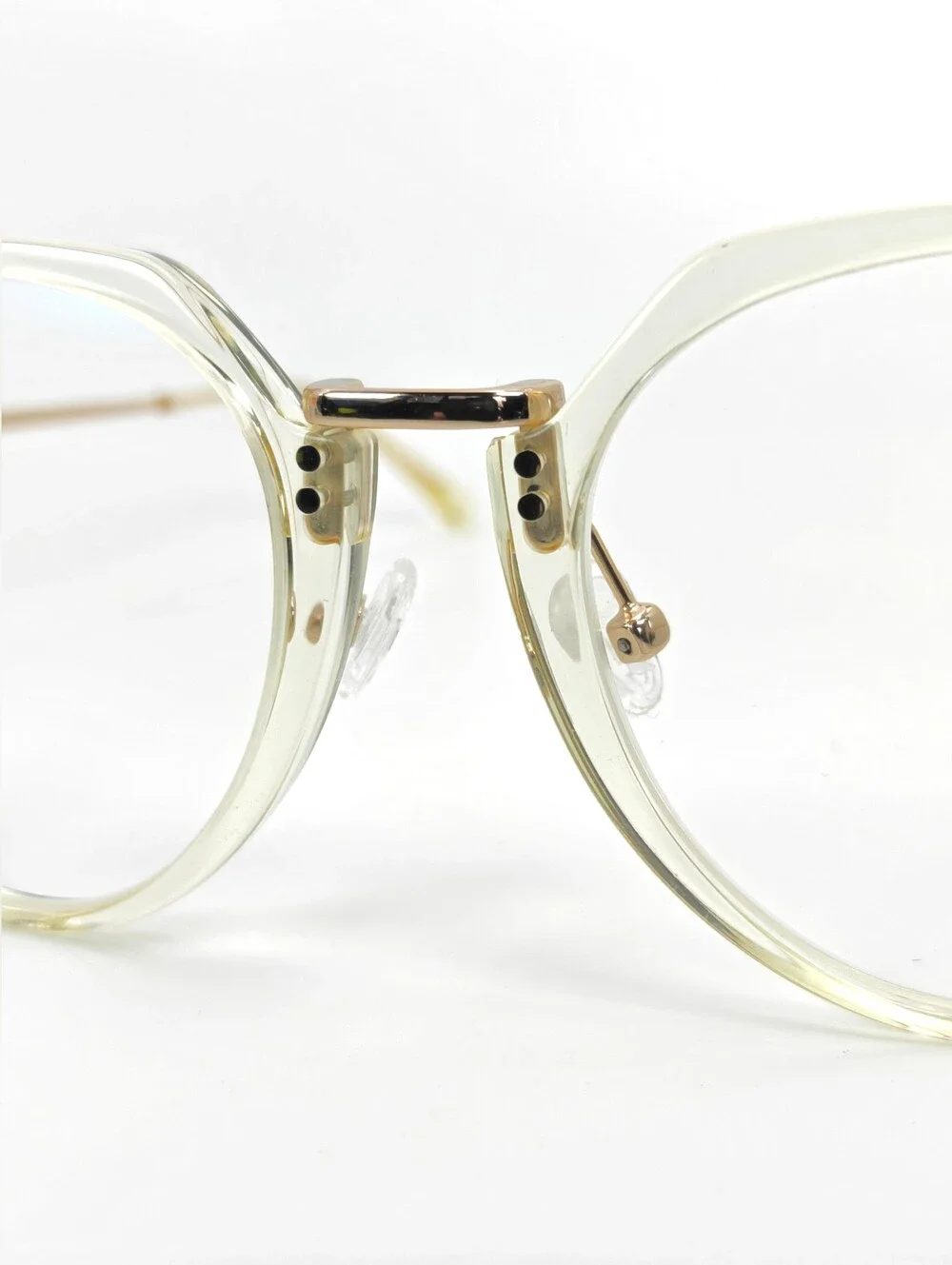 Tamara. Clear Round Frame Glasses. All Gold Accents are Metal.